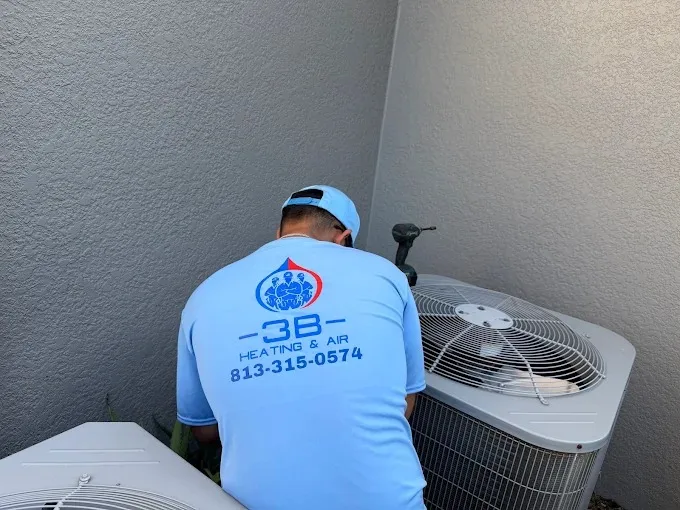 3B Heating & Air technician working on an outdoor AC unit