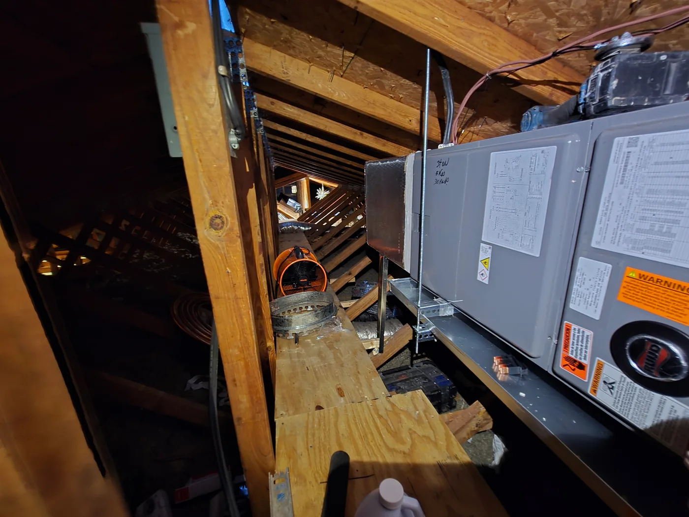 Side view of a Ruud air handler in an attic